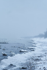 Snowy coast of the baltic sea. The sea is frozen in winter