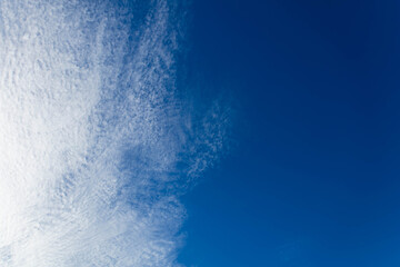 Beautiful white clouds covering thinly spread the sky on the blue of the sky background.