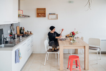 Adult freelance woman worker indoors at home home working