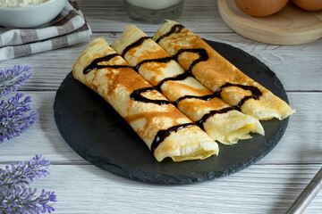 Sweet crepes with fresh red berries and chocolate