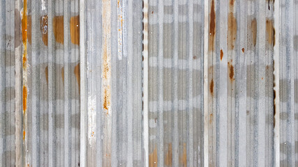 A rusty and weathered piece of corrugated metal. Corroded galvanized iron sheet. old zinc wall background.