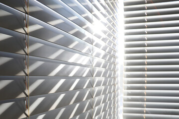 Bright sunshine seen through venetian blinds