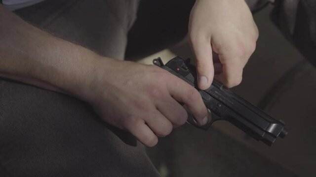 a man plays with his gun