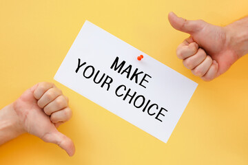 Male hands show signs of approval or disapproval. Postcard with the inscription Make your choice