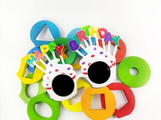 glasses written "happy birthday" with children's games on white background
