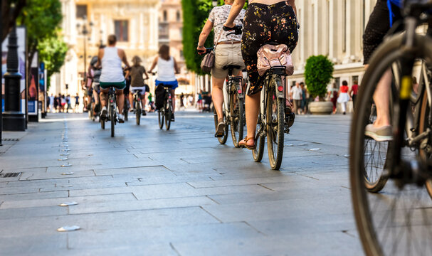 Many people in the city center in the pedestrian zone.who walk on foot and by bicycle