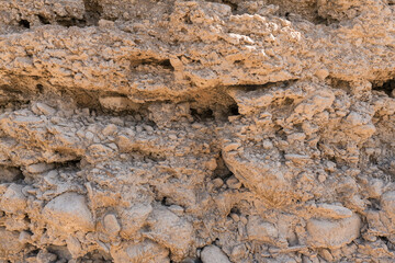stone wall and dried mud of a reservoir