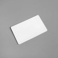 Photo of blank white business card on gray paper background. Branding ID template.