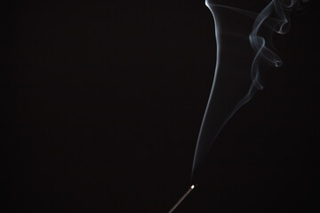 Incense burning giving of different patterns of smoke