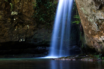 Fototapeta na wymiar long exposure picture of a waterfall in the woods