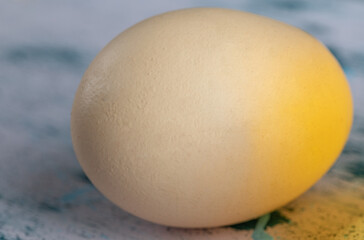 Brown egg lay on straw in a wooden crate