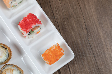 Mixed sushi set on a white ceramic board