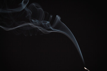 Incense burning giving of different patterns of smoke