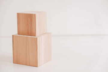 Two wooden blocks from natural wood on a white background. Copy, empty space for text