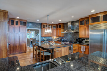 Beautiful expensive kitchen with granite, tile, and high end appliances.