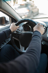 male hands on the steering wheel