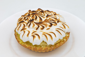 Delicious Large Lemon Meringue Tart on a White Plate