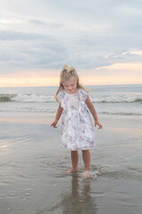 young girl in a dress has fun in the ocean water