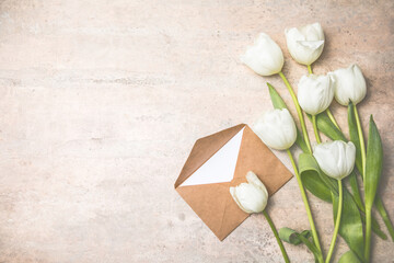 Fototapeta na wymiar White tulip flowers bouquet on gray background. Flat lay, top view, copy space. Banner for seasonal holiday, springtime concept, International Woman day, 8 march, Happy Easter greeting card