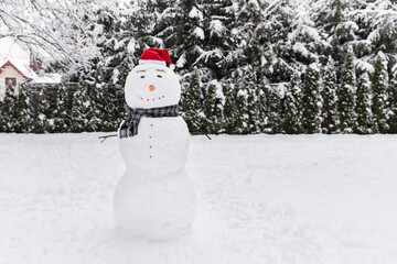 Snowman wearing a Santa Claus hat.