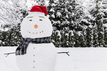 Snowman wearing a Santa Claus hat.