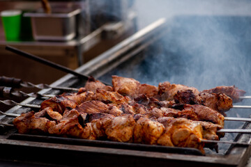  BBQ meat are turned over on the grill. Street food.