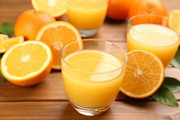 Naklejka na ściany i meble Delicious orange juice and fresh fruits on wooden table, closeup