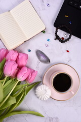 Purple tulips, coffee mug, white photo frame, laptop,  gemstone crystals, copy space