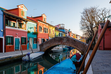 Fototapeta na wymiar Burano island with colorful houses and boats in winter afternoon