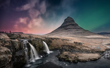 Northern lights aurora borealis over kirkjufell waterfall in Iceland