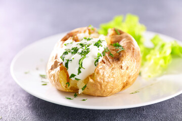 baked potato with cream and herbs