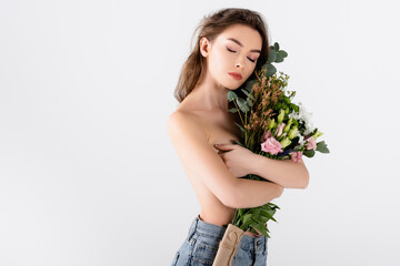 Shirtless and brunette woman holding flowers near chest isolated on grey