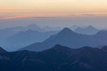 Obraz na płótnie Canvas blue hour mountain range layers at sunrise in the swiss alps
