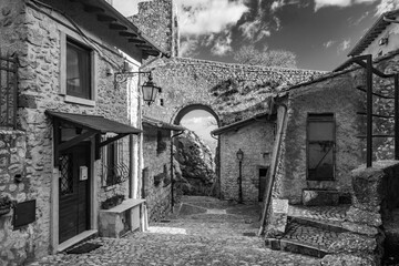February 12, 2021 - Castel San Pietro Romano, Lazio, Rome, Palestrina - A glimpse of the medieval village, with the cobbled alley between the houses. The arch formed by the stone bridge of the castle.