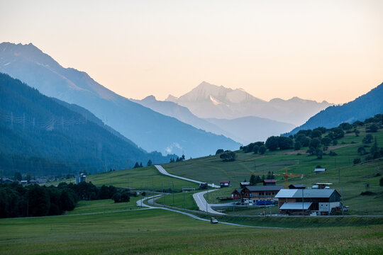 beautiful mountain peak seen from  alpine valley whit street and houses at sunset swiss alps goms valais