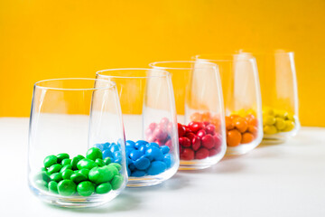 M&M's candy in the glasses, colorful candy, multicolored gradient