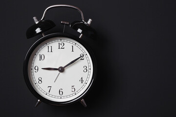 Alarm clock on a dark background in Low-key lighting
