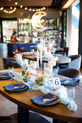 blue wedding cake stands on a blue table