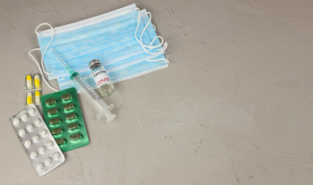 A vaccine and a syringe for injection. It is used for the prevention, immunization, and treatment of coronavirus infection. Medicine is an infectious concept. flatly. Copy space.