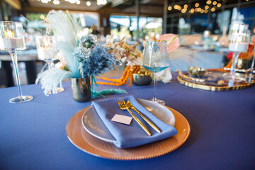 blue wedding cake stands on a blue table