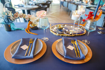 blue wedding cake stands on a blue table