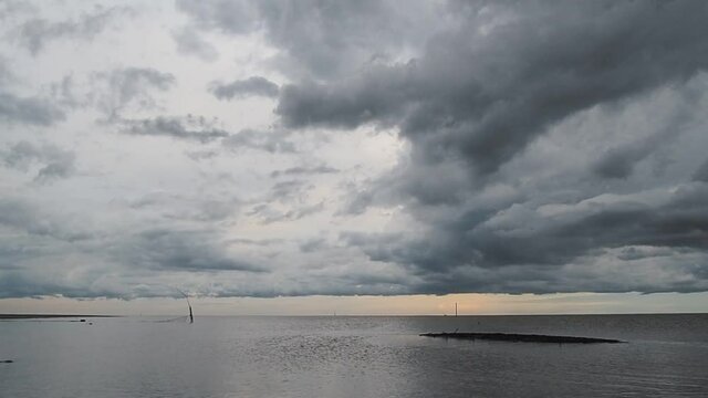 Scenic view of storm clouds over sea on horizon line

