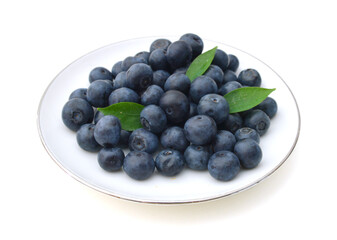 Blueberries in plate on white background