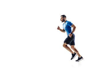 Fototapeta na wymiar Purpose. Caucasian professional male athlete, runner training isolated on white studio background. Muscular, sportive man. Concept of action, motion, youth, healthy lifestyle. Copyspace for ad.