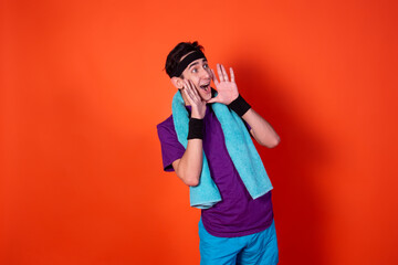 Funny young man and retro style. Sports and recreation. Bright colors. Orange background.