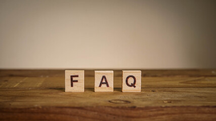 FAQ wording on wooden table. Frequently Ask Question concept.