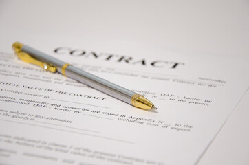 the pen is on the contract and the contract is on a white background
