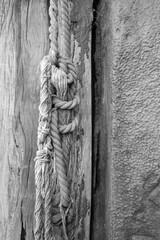 black and white image of nautical rope hanging from a wooden post at Old Leigh, Leigh-on-Sea, Essex, England