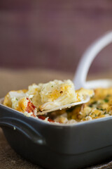 baked cauliflower with chicken fillet and vegetables topped with cheese