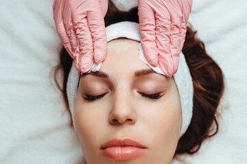 skin care creams .cosmetology and spa. pink gloves and sponge